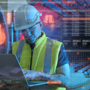 Cybersecurity worker on a laptop working on cybersecurity for manufacturing systems