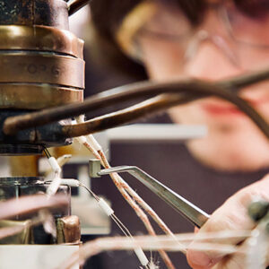 Process Improvement closeup of worker in safety gear setting up manufacturing equipment