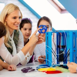 Student and Educator Training woman holding up a learning tool teaching a group of young children in a classroom environment.