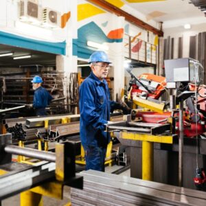 Side View Of Male Workers Wearing Protective Uniform And Helmets