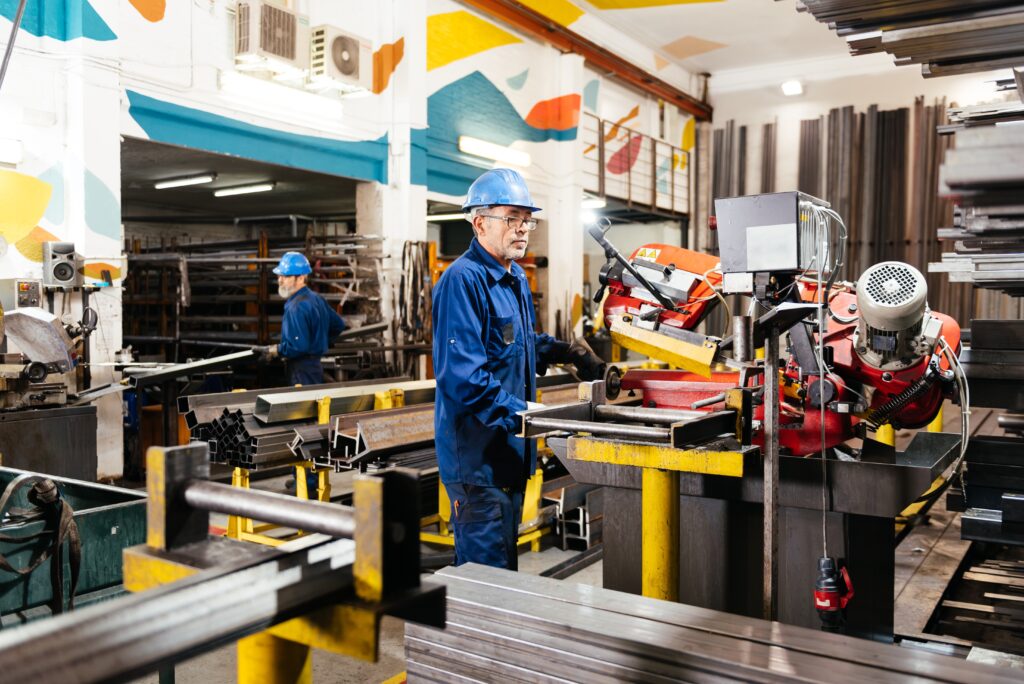 Side View Of Male Workers Wearing Protective Uniform And Helmets